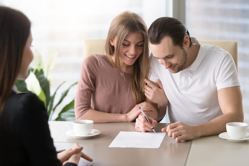 Smiling couple agreed to sign contract